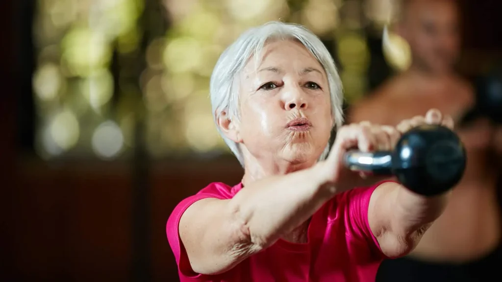 Toning Arms Without the Bulk: Is It Achievable? 1 Woman doing resistance band exercises for toned arms Dunstable