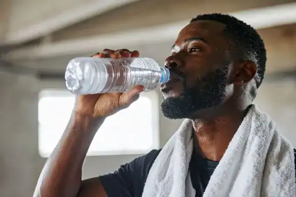 Hydration: The Secret Ingredient for a Toned Stomach and Enhanced Fitness 1 Image of man drinking water to improve hydration Dunstable after work out.